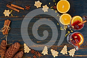 Christmas food background with copy space for text. Mulled wine with orange slices, cookies and hot winter spices - cinnamon