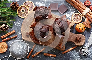 Christmas food. Chocolate muffins on wooden board