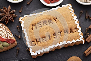 Christmas food concept - gingerbread cookie with merry christmas text baked on surface
