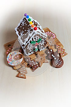 Christmas food decoration with gingerbread house and cookies cut in different shapes