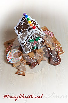 Christmas food decoration with gingerbread house and cookies cut in different shapes