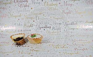 Christmas food photography mince pies and spice cinnamon sticks on xmas wrapping paper background