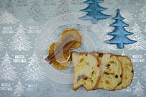 Christmas food photography picture with seasonal Italian panettone cake orange and cinnamon with glitter blue background