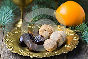 Christmas food still life: arabic dates, walnuts, persimmon