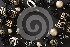 Christmas frame. Black Xmas background with striped gift boxes, luxury balls, confetti. Christmas frame, greeting card template,