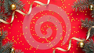 Christmas frame border. Fir tree branches decorated gold balls and ribbon, golden confetti stars on red background. Christmas,