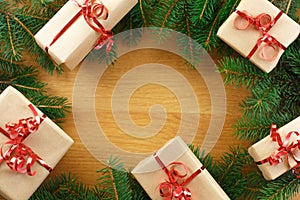 Christmas frame of colourful gift boxes, fir branches and cones on black background