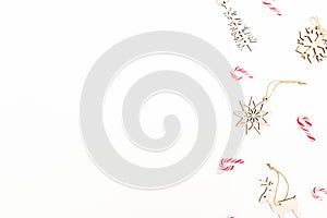 Christmas frame composition with tree decoration, snowflakes and candy canes on white background. Flat lay, top view. New Year con