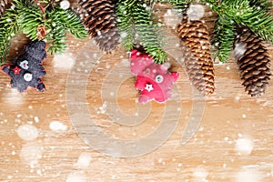 Christmas frame with fir branches, pine cones, textile decor and snow effect