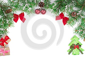 Christmas Frame of Fir tree branch with red bows isolated on white background with copy space for your text