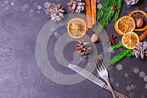 Christmas frame from fir tree branches and decorations on black background with space for text. Merry Christmas and Happy New Year