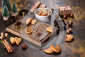 Christmas frame with fir tree branches, gingerbread cookies, spices and dried orange rings