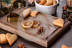 Christmas frame with fir tree branches, gingerbread cookies, spices and dried orange rings