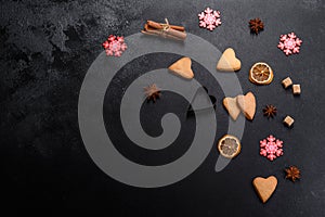 Christmas frame with fir tree branches, gingerbread cookies, spices and dried orange rings