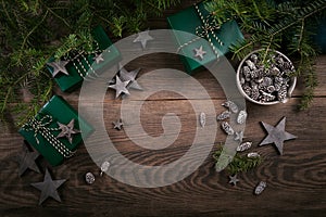 Christmas frame with gift boxes, wooden star decorations and spruce branches