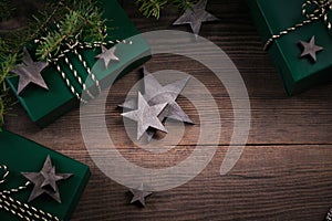 Christmas frame with gift boxes, wooden star decorations and spruce branches