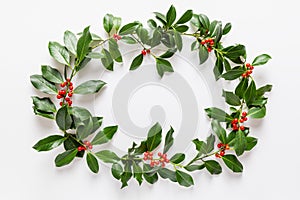 Christmas frame made from fresh holly berries
