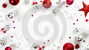 Christmas frame of red and silver decoration elements on white background top view. Xmas greeting card mockup, winter holidays