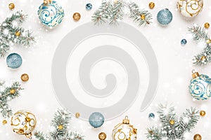 Christmas frame on snowy white background with gold blue decorations, copy space