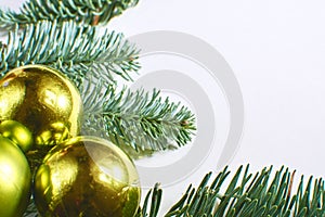 Christmas frame of spruce and Christmas decorations on a white background
