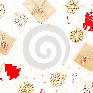 Christmas frame with tree decoration, snowflakes, gifts and candy canes on white background. Flat lay, top view. New Year concept