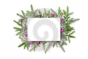 Christmas frame from a Christmas tree garland with decorations in pink tones. Christmas background with sheet of white paper and