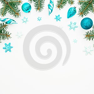 Christmas frame of winter trees, blue decoration and snowflake on white background. Holiday frame. Flat lay, top view