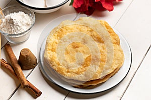 Christmas fritters with piloncillo and cinnamon on a white background. Mexican food photo