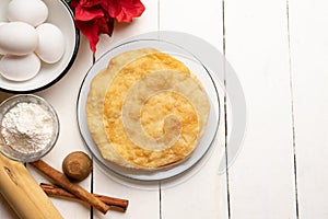 Christmas fritters with piloncillo and cinnamon on a white background. Mexican food photo