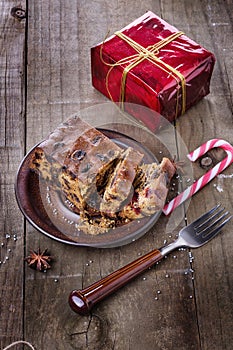 Christmas fruit cake over dark wooden background