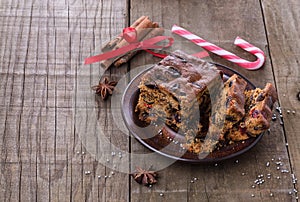 Christmas fruit cake over rustic wooden background