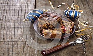 Christmas fruit cake over rustic wooden background