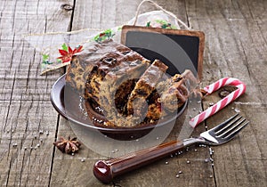 Christmas fruit cake over rustic wooden background