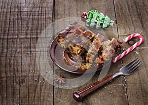 Christmas fruit cake over rustic wooden background