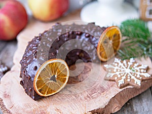 Christmas fruit cake, pudding on wooden plate with ginger cookies and chokolate-nut glaze. Copy space. Close up