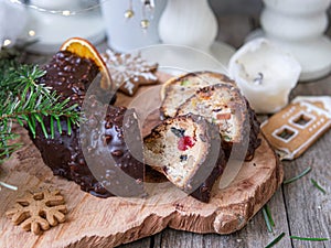 Christmas fruit cake, pudding on wooden plate with ginger cookies and chokolate-nut glaze. Copy space. Close up