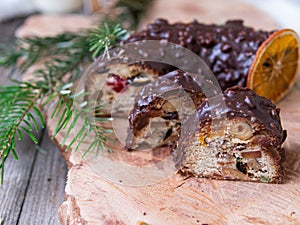 Christmas fruit cake, pudding on wooden plate with ginger cookies and chokolate-nut glaze. Copy space. Close up