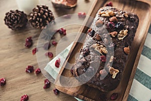 A christmas fruit cake on a wooden plate