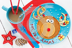 Christmas fun food for kids - santa reindeer pancake for creative and healthy breakfast photo