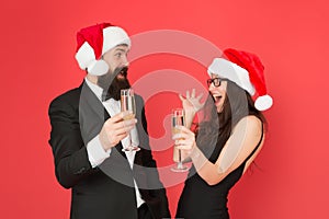 Christmas fun. formal couple visiting event ceremony. tuxedo man with woman in santa hat. merry christmas. business