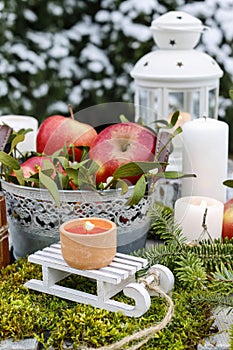 Christmas garden decoration with apples and lanterns