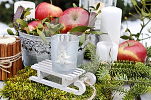 Christmas garden decoration with apples and lanterns