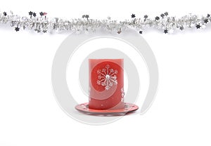 Christmas garland and candle on white