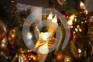 Christmas garland with candles and New Year\'s shiny balls. Traditional seasonal holidays and mood. Close-up