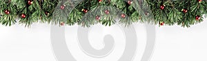 Christmas garland of Fir branches with red decoration on white background. Xmas and Happy New Year theme.