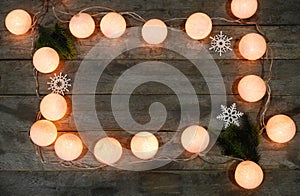 Christmas garland with fir tree branches and snowflakes on wooden background