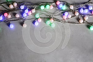 Christmas garland glowing on grey background