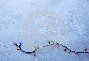 Christmas garland lights on blue background