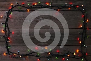 Christmas garland lights on grey background, copy space.