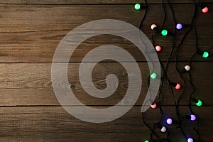 Christmas garland lights on grey background, copy space